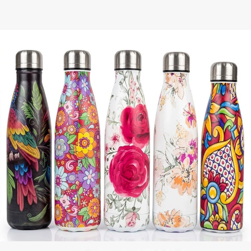 Printed Water Bottle for Everyday Use A Printed Water Bottle is a practical and stylish choice for carrying your favorite drink throughout the day. The slim bottle design is easy to carry, while the colorful printed patterns add a decorative touch to your everyday accessories. These bottles are available in a variety of eye-catching designs, including floral, artistic and multicolor patterns. Therefore, you can choose a style that matches your personal taste. In addition, the narrow shape makes the bottle suitable for many everyday situations. You can carry it to work, school, the gym, outdoor activities or during travel. Stylish Printed Water Bottle Designs Each bottle features an attractive exterior pattern. Some designs include bright flowers, while others feature colorful artistic prints. As a result, the bottle looks more stylish than a basic plain water container. It can also make a useful everyday accessory for people who enjoy colorful and decorative products. Moreover, the different patterns make it easier to choose a bottle for yourself or as a practical gift. Slim and Convenient Design The slim shape helps make the bottle comfortable to carry. It can be placed in many bags, backpacks or suitable bottle compartments depending on their size. Furthermore, the compact design makes storage easier when the bottle is not in use. You can use it for: Office School College Travel Gym Outdoor activities Daily commuting Home use Reusable Bottle for Daily Hydration Using a reusable bottle gives you a convenient way to keep water or another suitable drink close by during your daily routine. A Printed Water Bottle can be carried between home, work and other activities. Therefore, you can keep your drink easily accessible whenever needed. The screw-style top shown in the product image also gives the bottle a clean and simple appearance. Colorful Floral Patterns The printed exterior is one of the main highlights of this bottle collection. Floral designs provide a soft and elegant look, while multicolor patterns create a bold and vibrant appearance. In addition, having several designs available gives customers more choice. You can select a subtle floral pattern or choose a brighter artistic print. Why Choose This Printed Water Bottle? A Printed Water Bottle combines everyday convenience with attractive design. Its slim shape makes it useful for different occasions, while the printed exterior gives it a distinctive look. Whether you need a bottle for the office, travel or everyday use, this design offers a simple and stylish option. Explore our Drinkware & Water Bottles collection for more useful everyday products. Note: Print, color and design may vary according to the selected option. Check the actual product specifications for capacity, material and temperature-retention details before ordering. Key Features Stylish printed exterior Floral and colorful design options Slim and easy-to-carry shape Suitable for everyday use Useful for work, school and travel Reusable design Compact storage Multiple patterns available Suitable for personal use or gifting