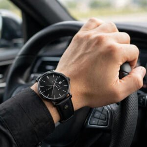 mens black leather watch with minimalist dial worn while driving