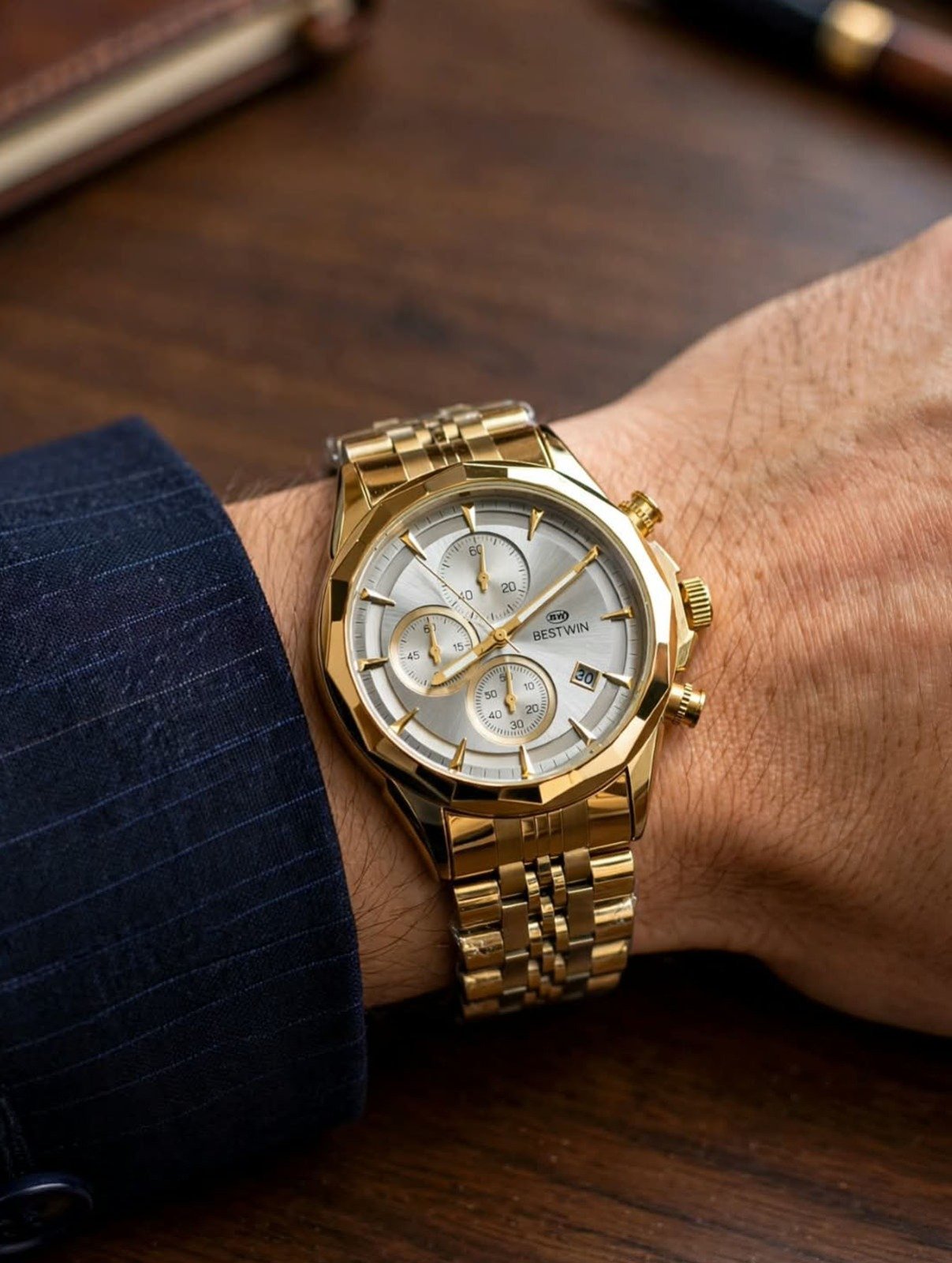 gold watch for men with metallic chain strap worn on wrist