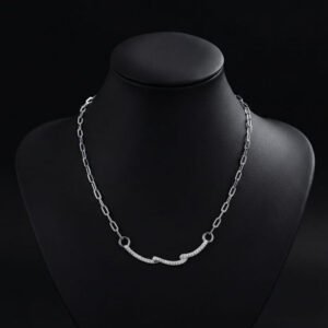 silver link chain necklace with pave stone wave design displayed on a mannequin