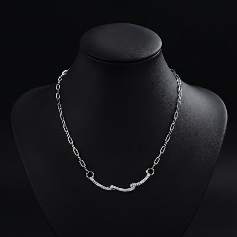 silver link chain necklace with pave stone wave design displayed on a mannequin
