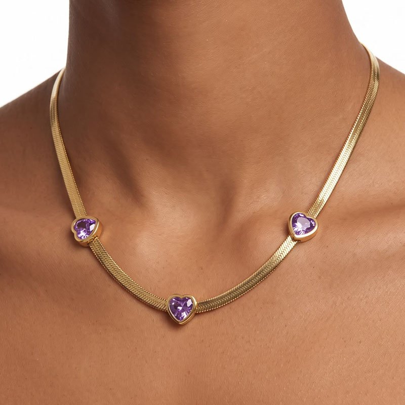 gold necklace for women with purple heart crystals on a herringbone chain worn on neck