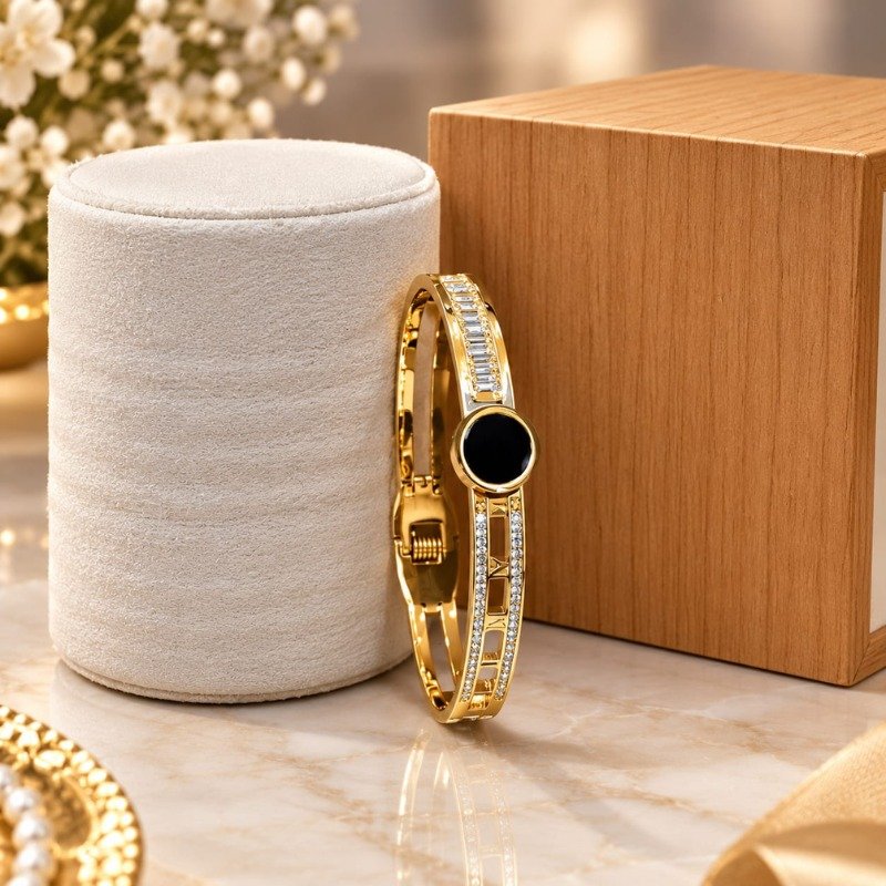 Elegant gold bracelet with black round stone and crystal detailing