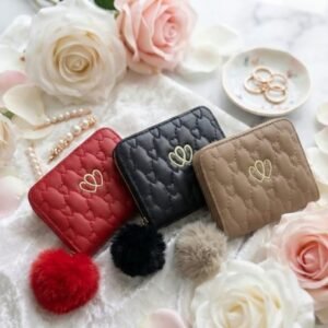 Heart quilted mini wallets with fluffy pom pom charms in red, black and beige