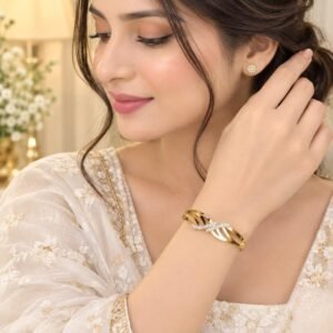 Gold criss cross bracelet with sparkling crystal accents worn on wrist