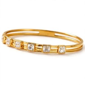Gold crystal bangle bracelet featuring square-cut sparkling stones on satin fabric