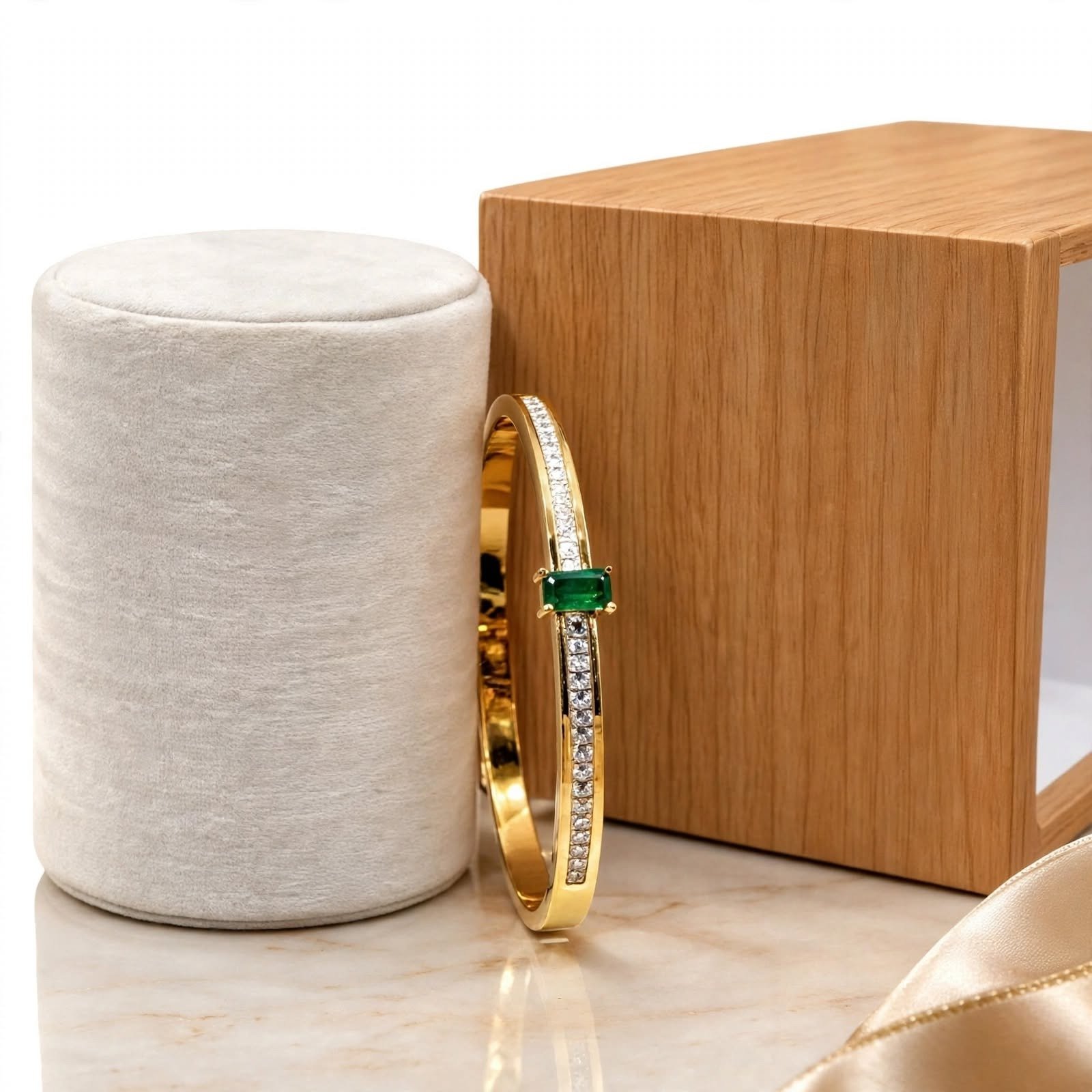 Elegant gold bracelet with green gemstone and crystal detailing
